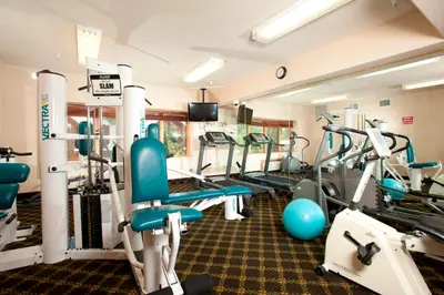 a gym with treadmills and machines in a room at Gateway 5070 in Keystone