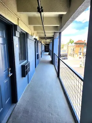 an empty hallway of a building with a blue door at Days Inn by Wyndham Denver Downtown in Denver