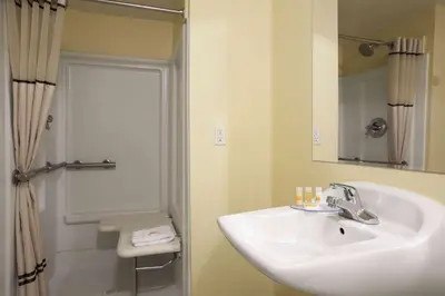 a bathroom with a sink and a shower at Days Inn by Wyndham Denver Downtown in Denver