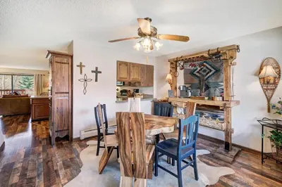 a dining room with a wooden table and chairs at Lagoon 762B Townhouse in Frisco