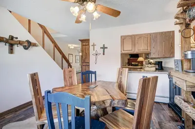 a kitchen and dining room with a wooden table and chairs at Lagoon 762B Townhouse in Frisco