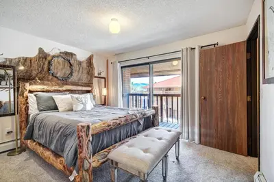 a bedroom with a large bed and a balcony at Lagoon 762B Townhouse in Frisco