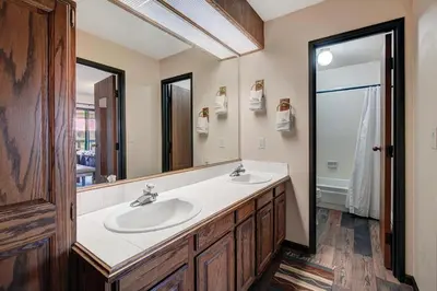 a bathroom with two sinks and a large mirror at Lagoon 762B Townhouse in Frisco