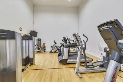 a gym with several treadmills and exercise bikes at Lagoon 762B Townhouse in Frisco