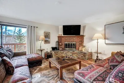 a living room with a couch and a fireplace at Lagoon 762B Townhouse in Frisco