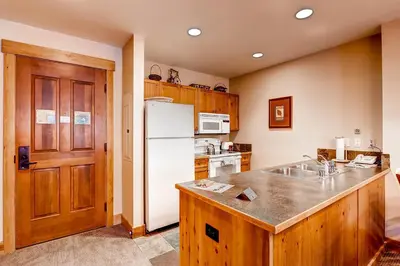 a kitchen with a white refrigerator and a sink at Springs 8831 in Keystone