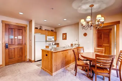 a kitchen and dining room with a table and chairs at Springs 8831 in Keystone