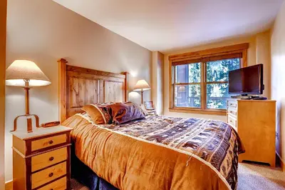 a bedroom with a bed and a tv and a window at Springs 8831 in Keystone