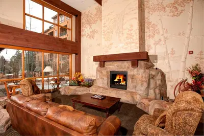 a living room with a couch and a fireplace at Springs 8831 in Keystone