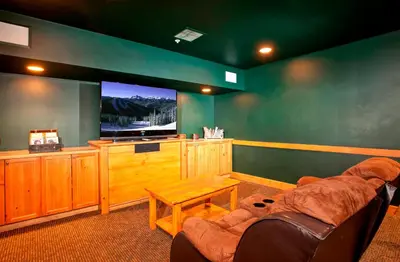 a living room with a couch and a flat screen tv at Springs 8831 in Keystone