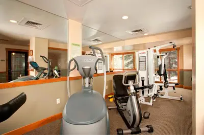 a gym with several exercise equipment in a room at Springs 8831 in Keystone