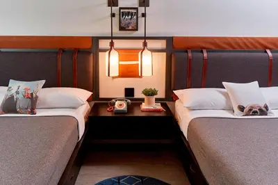 a room with two beds with a dog laying on them at MOXY Denver Cherry Creek in Denver