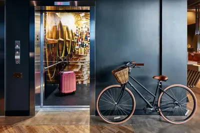a bike is parked next to a wall with a painting at MOXY Denver Cherry Creek in Denver