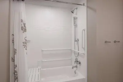 a white bathroom with a shower and a sink at Residence Inn by Marriott Boulder Canyon Boulevard in Boulder