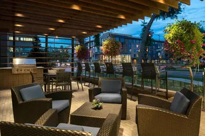 a patio with chairs and tables on a building at Residence Inn by Marriott Boulder Canyon Boulevard in Boulder