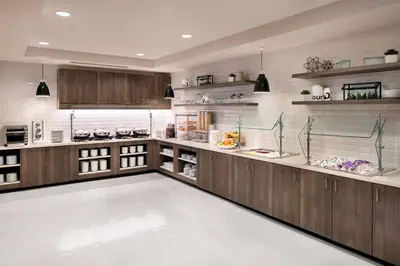 a large kitchen with wooden cabinets and shelves at Residence Inn by Marriott Boulder Canyon Boulevard in Boulder