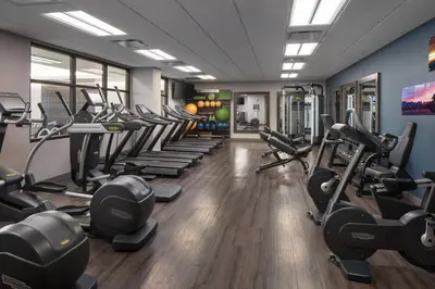 a gym with a row of treadmills and machines at Residence Inn by Marriott Boulder Canyon Boulevard in Boulder