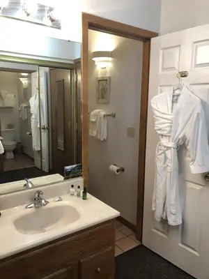 a bathroom with a sink and a mirror at Streamside on Fall River in Estes Park