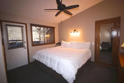 a bedroom with a bed and a ceiling fan at Streamside on Fall River in Estes Park