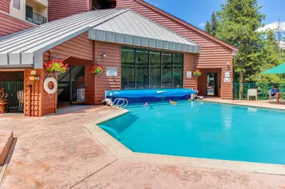 a swimming pool in front of a house at Iron Horse Studio in Winter Park