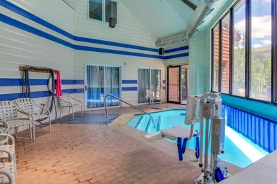 a swimming pool with blue and white striped walls and windows at Iron Horse Studio in Winter Park
