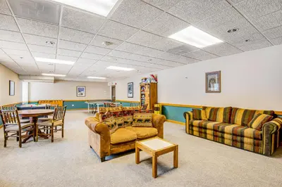 a living room with couches and a table and chairs at Iron Horse Studio in Winter Park
