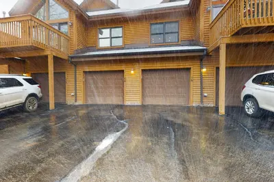 a car parked in a parking lot in front of a house at Snake River Village in Keystone