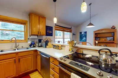 a kitchen with wooden cabinets and a stove top oven at Snake River Village in Keystone