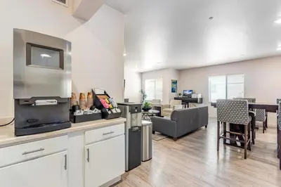 a kitchen and living room with a couch and a table at Parks Residential Denver in Centennial