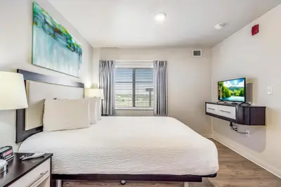 a bedroom with a large bed and a television at Parks Residential Denver in Centennial