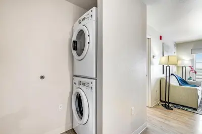a laundry room with a washer and dryer at Parks Residential Denver in Centennial