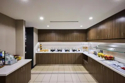 a large kitchen with wooden cabinets and a counter at Residence Inn by Marriott Denver Southwest/Littleton in Littleton