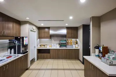 a large kitchen with wooden cabinets and a counter at Residence Inn by Marriott Denver Southwest/Littleton in Littleton