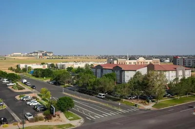 an aerial view of a city with a parking lot at Courtyard by Marriott Denver Airport in Denver