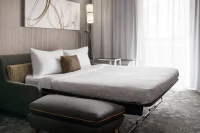 a hotel room with a bed and a chair at Courtyard by Marriott Boulder in Boulder