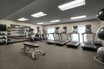a gym with several treadmills and elliptical machines at Courtyard by Marriott Boulder in Boulder