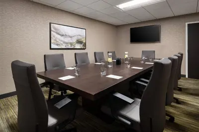 a conference room with a large wooden table and chairs at Courtyard by Marriott Boulder in Boulder