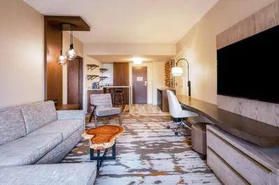 a living room with a couch and a flat screen tv at Hilton Denver City Center in Denver