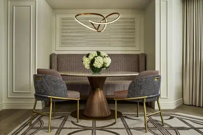 a dining room with a table with a vase of flowers at The Ritz-Carlton, Denver in Denver