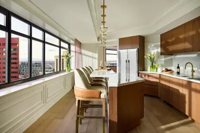a kitchen with a counter with chairs and windows at The Ritz-Carlton, Denver in Denver
