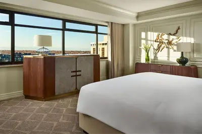 a bedroom with a large bed and a large window at The Ritz-Carlton, Denver in Denver