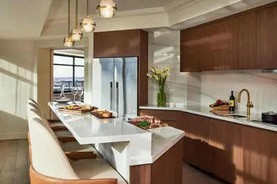 a kitchen with a large white island in a room at The Ritz-Carlton, Denver in Denver