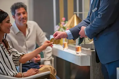 a man is handing a woman a piece of jewelry at Hotel Clio, a Luxury Collection Hotel, Denver Cherry Creek in Denver