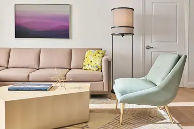 a living room with a couch and a chair at Hotel Clio, a Luxury Collection Hotel, Denver Cherry Creek in Denver