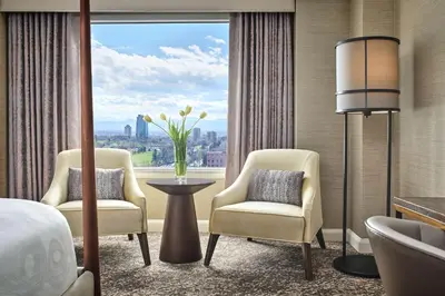 a hotel room with two chairs and a large window at Hotel Clio, a Luxury Collection Hotel, Denver Cherry Creek in Denver