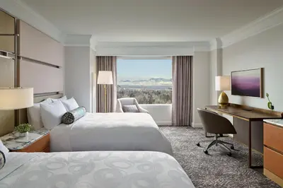 a hotel room with two beds and a desk and a computer at Hotel Clio, a Luxury Collection Hotel, Denver Cherry Creek in Denver