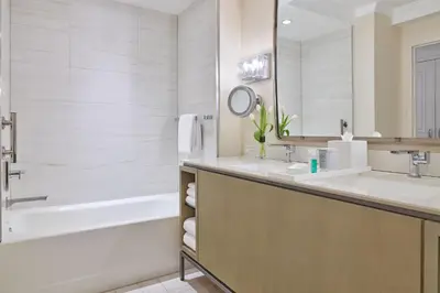 a bathroom with a tub and two sinks and a bath tub at Hotel Clio, a Luxury Collection Hotel, Denver Cherry Creek in Denver