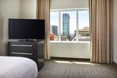 a hotel room with a television and a large window at Residence Inn Denver City Center in Denver