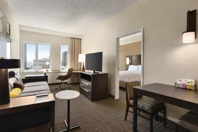 a hotel room with a bed and a living room at Residence Inn Denver City Center in Denver