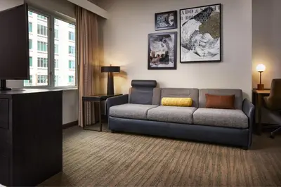 a living room with a couch and a tv at Residence Inn Denver City Center in Denver